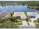 Well-maintained home showcasing beautiful landscaping, a spacious driveway, and a scenic lake at 201 Largo Dr, Kissimmee, FL 34759