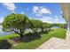 Landscaped backyard featuring well-maintained lawn and lake views offers outdoor enjoyment at 201 Largo Dr, Kissimmee, FL 34759