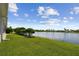 Expansive backyard with lush green grass and serene lake views, perfect for outdoor enjoyment at 201 Largo Dr, Kissimmee, FL 34759