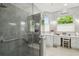 Bathroom boasts a glass shower with handrails, a vanity area, and bright, natural light at 201 Largo Dr, Kissimmee, FL 34759