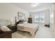 Bright bedroom featuring neutral walls, carpet floors, and two side tables with lamps at 201 Largo Dr, Kissimmee, FL 34759