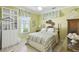 Cozy bedroom with cool-toned walls, striped bedding, and ample natural light at 201 Largo Dr, Kissimmee, FL 34759