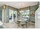 Dining room featuring a round white table and seating for six with a view of the lake at 201 Largo Dr, Kissimmee, FL 34759