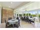 Sunroom dining area featuring expansive windows, lake views, and large dining table at 201 Largo Dr, Kissimmee, FL 34759