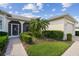 Inviting front entrance with a screened door, lush garden, and paved walkway at 201 Largo Dr, Kissimmee, FL 34759