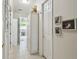 Hallway with tile floors, white walls, crown molding, and access to the kitchen at 201 Largo Dr, Kissimmee, FL 34759