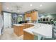 Well-lit kitchen with island, bar seating, and access to other living spaces at 201 Largo Dr, Kissimmee, FL 34759