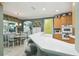 Bright and airy kitchen with bar seating, stainless steel appliances, and dining area at 201 Largo Dr, Kissimmee, FL 34759