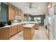 Well-lit kitchen features wood cabinets, a center island, modern appliances, and tile flooring at 201 Largo Dr, Kissimmee, FL 34759