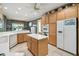 Bright kitchen with wooden cabinets, tile floors, a center island, and white countertops at 201 Largo Dr, Kissimmee, FL 34759