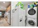 Well-equipped laundry area with large refrigerator, washer, dryer, and plenty of storage space at 201 Largo Dr, Kissimmee, FL 34759