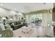 Cozy living room with large windows, tile flooring, ceiling fan, and patio access at 201 Largo Dr, Kissimmee, FL 34759