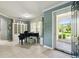 Elegant living room with grand piano, display cabinet, and view of the front entrance at 201 Largo Dr, Kissimmee, FL 34759