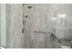 Close-up of shower with chrome fixtures, grab bars and gray marbled tiles at 201 Largo Dr, Kissimmee, FL 34759