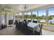 Bright sunroom featuring a dining table, ceiling fan, and large windows with a view of the lake at 201 Largo Dr, Kissimmee, FL 34759
