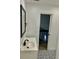 Bathroom features vanity and decorative floor, with doorway view to stairs in the home at 2031 Balboa Way, Kissimmee, FL 34741