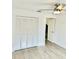 Bedroom boasts a ceiling fan, closet with louvered doors and view to an open doorway at 2031 Balboa Way, Kissimmee, FL 34741