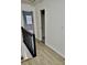 A hallway with wood floors and black railing leading to bedrooms at 2031 Balboa Way, Kissimmee, FL 34741