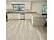 Bright kitchen features gray granite countertops, stainless steel appliances, and modern wood flooring at 2031 Balboa Way, Kissimmee, FL 34741