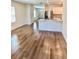 Bright living room featuring wood floors leading to an open kitchen with stainless steel appliances at 2031 Balboa Way, Kissimmee, FL 34741