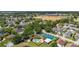 Neighborhood aerial view showcasing pool, tennis court, and pond near the subject property at 2146 Fish Eagle St, Clermont, FL 34714