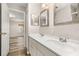 The bathroom features double sinks, framed mirrors, updated fixtures and a view to the Primary bedroom at 2146 Fish Eagle St, Clermont, FL 34714