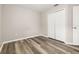 This bedroom features wood flooring and neutral walls, offering a simple and clean aesthetic at 2146 Fish Eagle St, Clermont, FL 34714