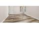 A bedroom with wood flooring and neutral paint throughout the room and an entryway at 2146 Fish Eagle St, Clermont, FL 34714