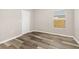 Bedroom features light gray walls, wood-look flooring, and a window with blinds at 2146 Fish Eagle St, Clermont, FL 34714
