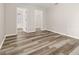 A bedroom with wood flooring showcasing entryways into the walk-in closet and en-suite bathroom at 2146 Fish Eagle St, Clermont, FL 34714