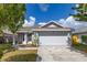 Charming single-story home featuring an attached two car garage and well-maintained lawn at 2146 Fish Eagle St, Clermont, FL 34714