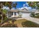 Charming single-story home with a well-maintained lawn and attached two-car garage at 2146 Fish Eagle St, Clermont, FL 34714