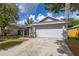 Single-story home with attached two-car garage and well-maintained landscaping at 2146 Fish Eagle St, Clermont, FL 34714