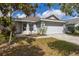 Charming single-story home featuring a manicured lawn and a two-car garage at 2146 Fish Eagle St, Clermont, FL 34714