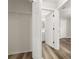 Hallway with wood-look floors leads to the bedroom and bathroom with a closet at 2146 Fish Eagle St, Clermont, FL 34714