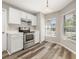Bright kitchen area with stainless steel appliances, white cabinets, and a cozy breakfast nook at 2146 Fish Eagle St, Clermont, FL 34714