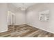 The living room shows a view to the hallway and the kitchen with wood-look floors at 2146 Fish Eagle St, Clermont, FL 34714