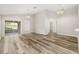 Spacious living room with hardwood flooring, high ceilings, and access to a screened patio at 2146 Fish Eagle St, Clermont, FL 34714