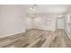 Spacious living room with vaulted ceiling, wood-look floors, and a view to the kitchen at 2146 Fish Eagle St, Clermont, FL 34714