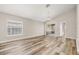 Bright living room with hardwood flooring, neutral walls, and access to a screened patio at 2146 Fish Eagle St, Clermont, FL 34714