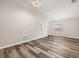 Living room features wood-look flooring, vaulted ceiling, and view of kitchen pass-through at 2146 Fish Eagle St, Clermont, FL 34714