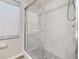 This shower is enclosed with glass and has subway tile walls and mosaic tile flooring at 2146 Fish Eagle St, Clermont, FL 34714