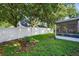 Well-maintained backyard with lush lawn, a garden, and a view of the screened patio at 2225 Maryday Ct, Orlando, FL 32812