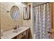 Bathroom featuring a sink and vanity with a tub and shower with a blue patterned shower curtain at 2225 Maryday Ct, Orlando, FL 32812
