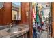 Bathroom vanity area with sink, next to a walk-in closet with organized storage at 2225 Maryday Ct, Orlando, FL 32812