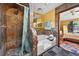 Modern bathroom features a tiled shower, tub, and access to the main bedroom at 2225 Maryday Ct, Orlando, FL 32812