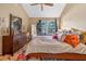 Bedroom featuring a floral bedspread, a ceiling fan, and a view of the window at 2225 Maryday Ct, Orlando, FL 32812