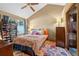 Bedroom featuring a floral bedspread, a ceiling fan, and a large window with shoe shelves at 2225 Maryday Ct, Orlando, FL 32812