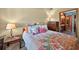 Bedroom featuring a floral bedspread, a ceiling fan, and a dresser at 2225 Maryday Ct, Orlando, FL 32812