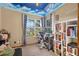 The bedroom features a whimsical cloud painted ceiling, complemented by natural light from the window at 2225 Maryday Ct, Orlando, FL 32812